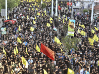 Hezbollah fighters and mourners are attending the funeral ceremony of slain top commander Fuad Shukr in Beirut's southern suburbs, on August...