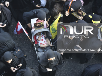 Hezbollah fighters and mourners are attending the funeral ceremony of slain top commander Fuad Shukr in Beirut's southern suburbs, on August...