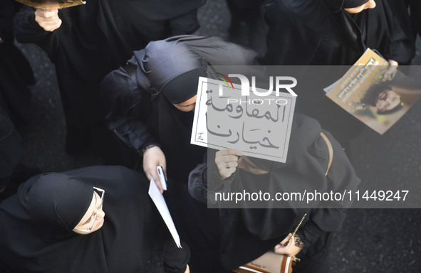 Hezbollah fighters and mourners are attending the funeral ceremony of slain top commander Fuad Shukr in Beirut's southern suburbs, on August...