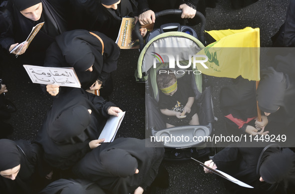 Hezbollah fighters and mourners are attending the funeral ceremony of slain top commander Fuad Shukr in Beirut's southern suburbs, on August...