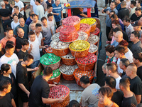 Workers are loading and unloading swimming crabs at the dock of Zhoushan International Aquatic City in Zhoushan, China, on August 2, 2024. (