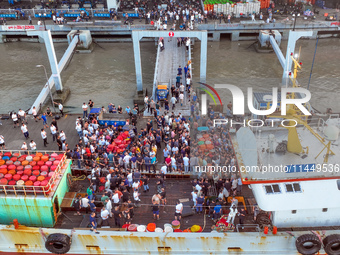 Workers are loading and unloading swimming crabs at the dock of Zhoushan International Aquatic City in Zhoushan, China, on August 2, 2024. (