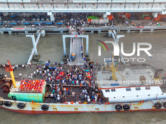 Workers are loading and unloading swimming crabs at the dock of Zhoushan International Aquatic City in Zhoushan, China, on August 2, 2024. (