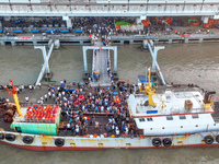 Workers are loading and unloading swimming crabs at the dock of Zhoushan International Aquatic City in Zhoushan, China, on August 2, 2024. (