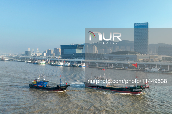 Fishing boats are passing through the dock of Zhoushan International Aquatic City in Zhoushan City, Zhejiang province, in Zhoushan, China, o...