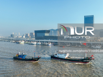 Fishing boats are passing through the dock of Zhoushan International Aquatic City in Zhoushan City, Zhejiang province, in Zhoushan, China, o...