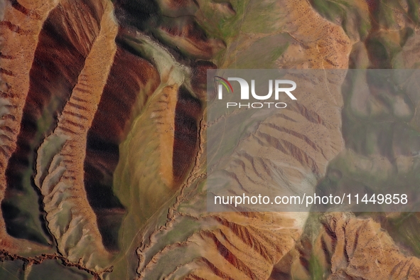 Colorful mountains are being seen on the 147 county road in Changji Hui Autonomous Prefecture, Xinjiang province, China, on July 25, 2024. 