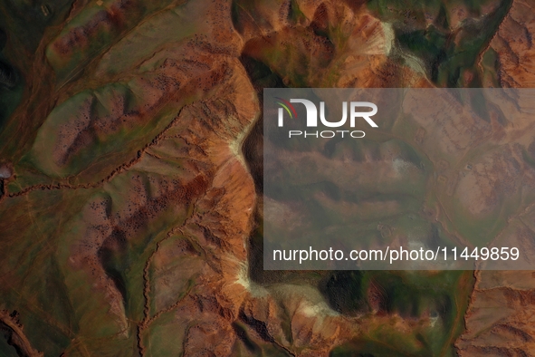 Colorful mountains are being seen on the 147 county road in Changji Hui Autonomous Prefecture, Xinjiang province, China, on July 25, 2024. 