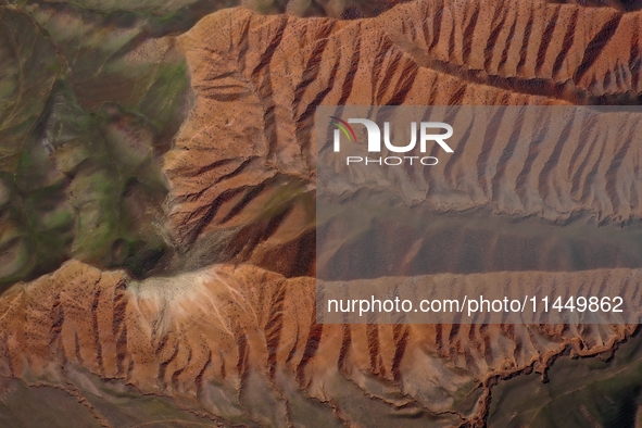 Colorful mountains are being seen on the 147 county road in Changji Hui Autonomous Prefecture, Xinjiang province, China, on July 25, 2024. 