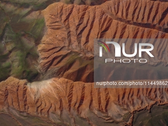 Colorful mountains are being seen on the 147 county road in Changji Hui Autonomous Prefecture, Xinjiang province, China, on July 25, 2024. (