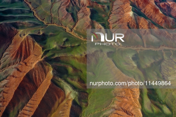 Colorful mountains are being seen on the 147 county road in Changji Hui Autonomous Prefecture, Xinjiang province, China, on July 25, 2024. 