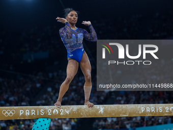 Simone Biles of Team United States competes on the balance beam during the Artistic Gymnastics Women's All-Around Final on day six of the Ol...