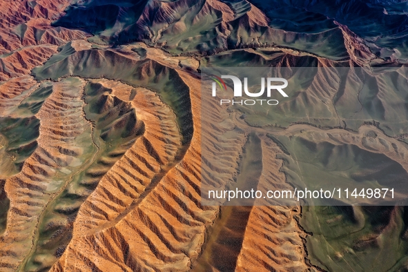 Colorful mountains are being seen on the 147 county road in Changji Hui Autonomous Prefecture, Xinjiang province, China, on July 25, 2024. 