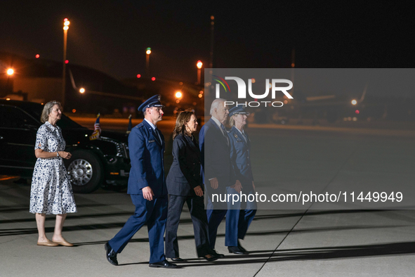 U.S. President Joe Biden and Democratic presidential candidate, U.S. Vice President Kamala Harris walk on the tarmac before welcoming home f...