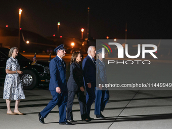 U.S. President Joe Biden and Democratic presidential candidate, U.S. Vice President Kamala Harris walk on the tarmac before welcoming home f...