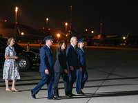 U.S. President Joe Biden and Democratic presidential candidate, U.S. Vice President Kamala Harris walk on the tarmac before welcoming home f...