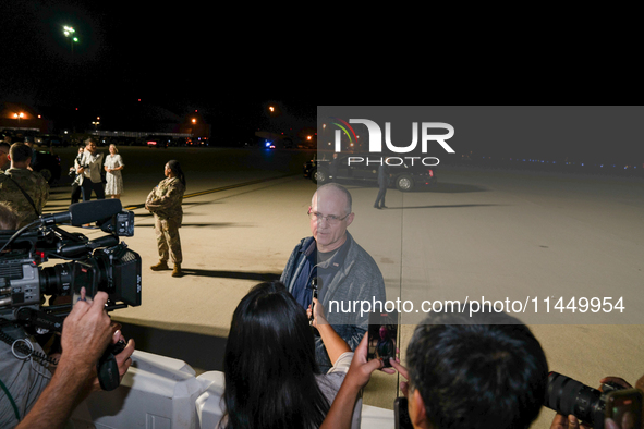 U.S. President Joe Biden and Democratic presidential candidate, U.S. Vice President Kamala Harris walk on the tarmac after welcoming home fr...