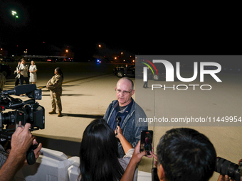 U.S. President Joe Biden and Democratic presidential candidate, U.S. Vice President Kamala Harris walk on the tarmac after welcoming home fr...