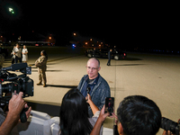 U.S. President Joe Biden and Democratic presidential candidate, U.S. Vice President Kamala Harris walk on the tarmac after welcoming home fr...