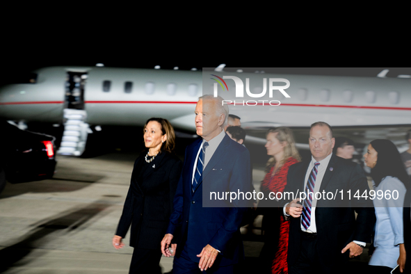 U.S. President Joe Biden and Democratic presidential candidate, U.S. Vice President Kamala Harris walk on the tarmac after welcoming home fr...