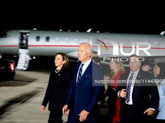 U.S. President Joe Biden and Democratic presidential candidate, U.S. Vice President Kamala Harris walk on the tarmac after welcoming home fr...