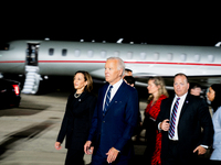 U.S. President Joe Biden and Democratic presidential candidate, U.S. Vice President Kamala Harris walk on the tarmac after welcoming home fr...