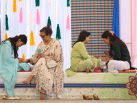 Nepali Hindu women are painting their palms with Heena, commonly called ''mehendi,'' at a fair in Kathmandu, Nepal, on August 2, 2024, as pa...