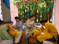 Nepali Hindu women are painting their palms with Heena, commonly called ''mehendi,'' at a fair in Kathmandu, Nepal, on August 2, 2024, as pa...