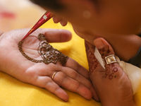 Nepali Hindu women are painting their palms with Heena, commonly called ''mehendi,'' at a fair in Kathmandu, Nepal, on August 2, 2024, as pa...