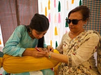 Nepali Hindu women are painting their palms with Heena, commonly called ''mehendi,'' at a fair in Kathmandu, Nepal, on August 2, 2024, as pa...