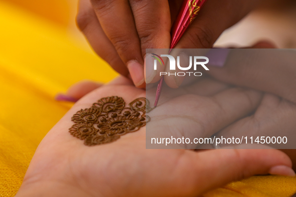 Nepali Hindu women are painting their palms with Heena, commonly called ''mehendi,'' at a fair in Kathmandu, Nepal, on August 2, 2024, as pa...