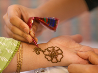 Nepali Hindu women are painting their palms with Heena, commonly called ''mehendi,'' at a fair in Kathmandu, Nepal, on August 2, 2024, as pa...