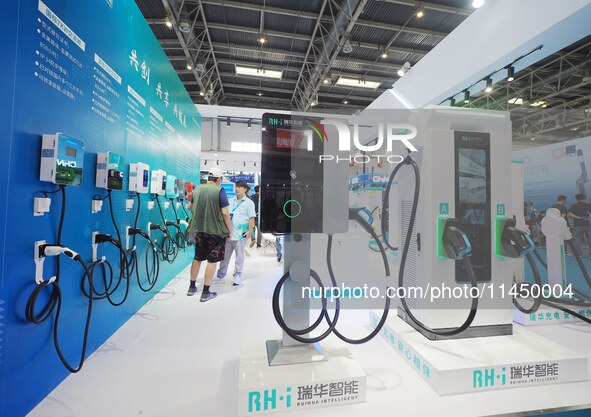 Visitors are visiting a ''smart charging pile'' at the 13th Beijing International Automobile Manufacturing Expo 2024 in Beijing, China, on A...