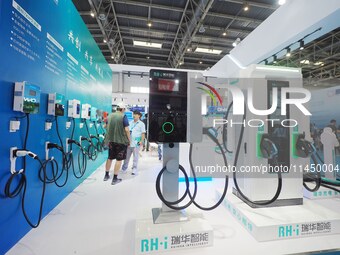 Visitors are visiting a ''smart charging pile'' at the 13th Beijing International Automobile Manufacturing Expo 2024 in Beijing, China, on A...