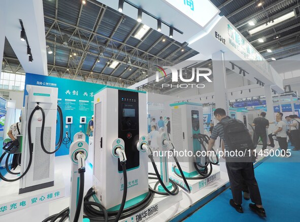 Visitors are visiting a ''smart charging pile'' at the 13th Beijing International Automobile Manufacturing Expo 2024 in Beijing, China, on A...