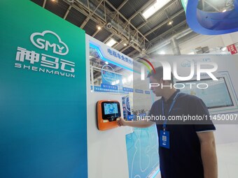 Visitors are experiencing a ''smart battery car charging pile'' at the 13th Beijing International Automobile Manufacturing Expo 2024 in Beij...