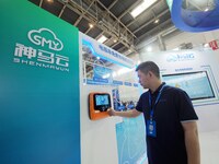 Visitors are experiencing a ''smart battery car charging pile'' at the 13th Beijing International Automobile Manufacturing Expo 2024 in Beij...