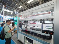 Visitors are visiting the ''Intelligent Magnetic Drive Conveying System'' at the 13th Beijing International Automobile Manufacturing Expo 20...