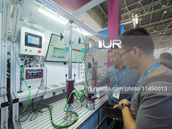 Visitors are visiting a ''smart screwdriver'' at the 13th Beijing International Automobile Manufacturing Expo 2024 in Beijing, China, on Aug...