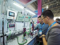 Visitors are visiting a ''smart screwdriver'' at the 13th Beijing International Automobile Manufacturing Expo 2024 in Beijing, China, on Aug...