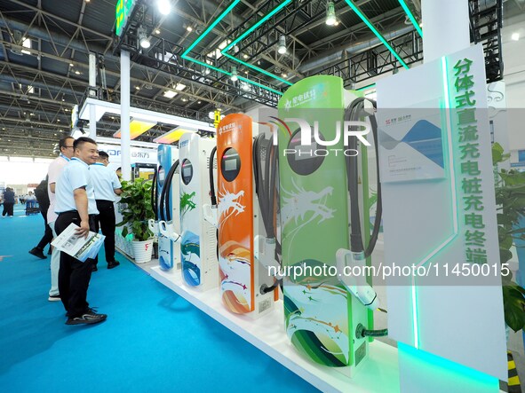 Visitors are visiting a ''split DC charging pile'' at the 13th Beijing International Automobile Manufacturing Expo 2024 in Beijing, China, o...