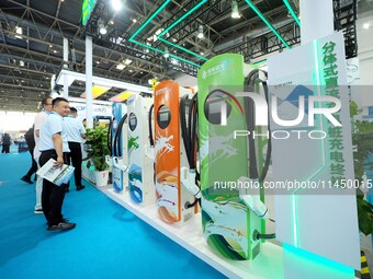 Visitors are visiting a ''split DC charging pile'' at the 13th Beijing International Automobile Manufacturing Expo 2024 in Beijing, China, o...