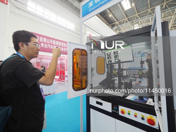 Visitors are visiting a ''CCD visual inspection machine'' at the 13th Beijing International Automobile Manufacturing Expo 2024 in Beijing, C...