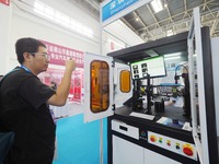 Visitors are visiting a ''CCD visual inspection machine'' at the 13th Beijing International Automobile Manufacturing Expo 2024 in Beijing, C...