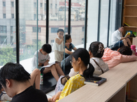 People are resting on the floor at a bookstore in Shanghai, China, on August 2, 2024, as high temperatures are persisting for the upcoming d...