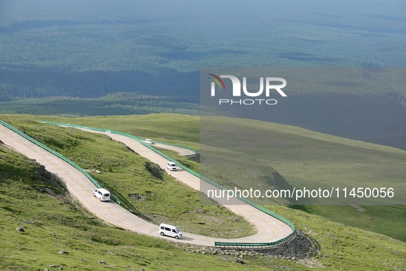 Tourists are taking a ferry bus to visit Tianchi Lake on the main peak of Changbai Mountain in Changbai Mountain, Northeast China's Jilin pr...