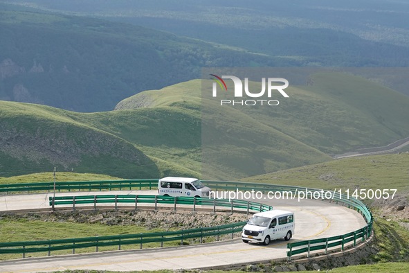 Tourists are taking a ferry bus to visit Tianchi Lake on the main peak of Changbai Mountain in Changbai Mountain, Northeast China's Jilin pr...