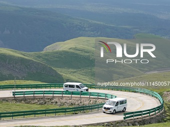 Tourists are taking a ferry bus to visit Tianchi Lake on the main peak of Changbai Mountain in Changbai Mountain, Northeast China's Jilin pr...