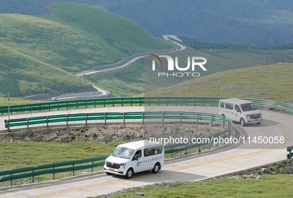 Tourists are taking a ferry bus to visit Tianchi Lake on the main peak of Changbai Mountain in Changbai Mountain, Northeast China's Jilin pr...