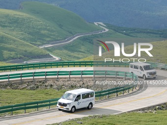 Tourists are taking a ferry bus to visit Tianchi Lake on the main peak of Changbai Mountain in Changbai Mountain, Northeast China's Jilin pr...